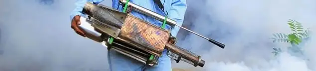 Fumigation technician using a fogger for deep pest treatment in Fort Collins, CO